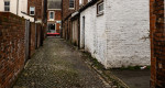 © Rodney Dinnen  <em>Alley with Christmas tree and Aston Martin</em>